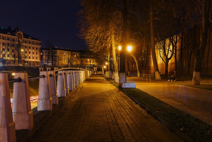 Night view of a city embankment with street lights and buildings