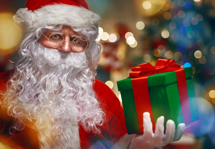Santa Claus holding a Christmas gift