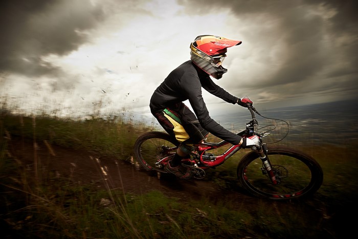 Mountain biker in helmet riding downhill