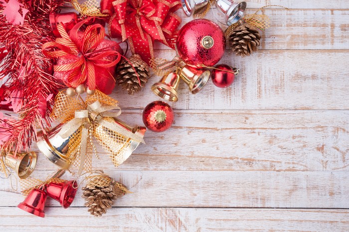 Christmas ornaments and pine cones on wood