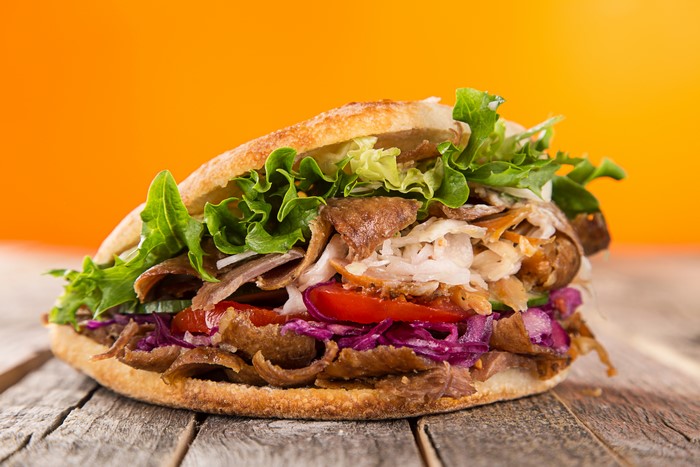 Doner Kebab Sandwich with Vegetables on Wood Planks