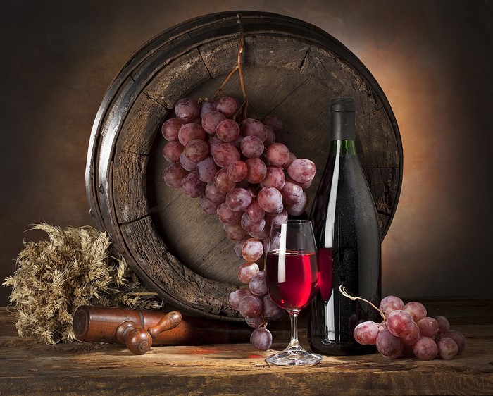 Still life with wine barrel, grapes, and wine bottle