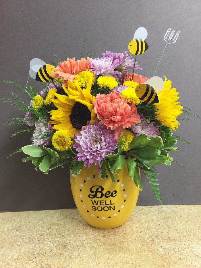 Flower arrangement with bees in a yellow vase