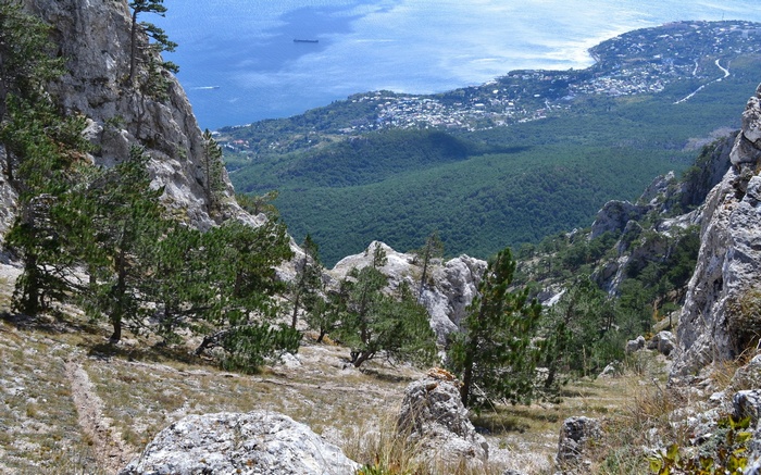 Mountainous landscape overlooking a coastal town and the sea