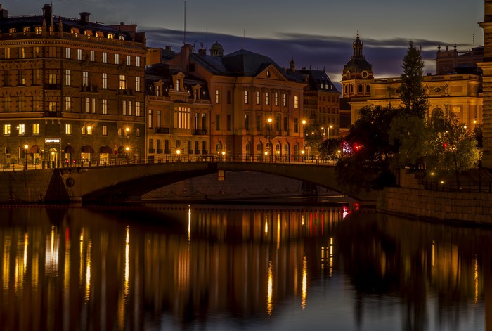Stockholm at night with bridge and river reflections