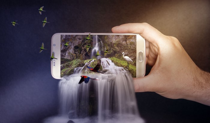 Smartphone displaying a waterfall with parrots and a bird