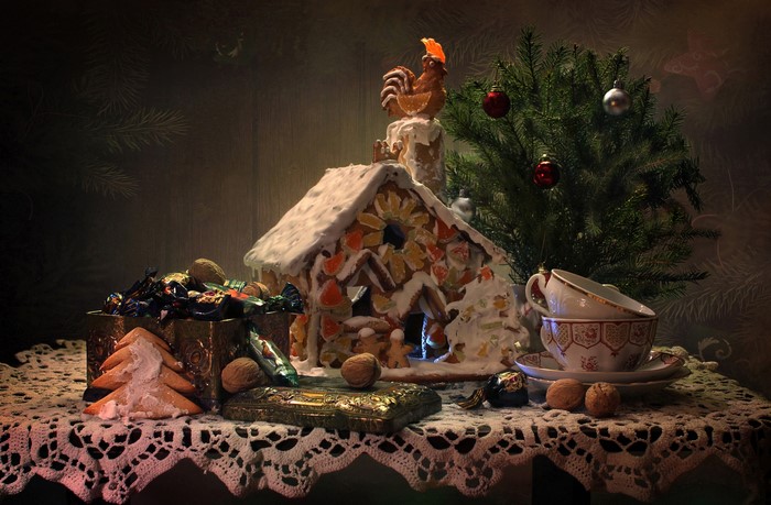 Christmas still life with gingerbread house and sweets
