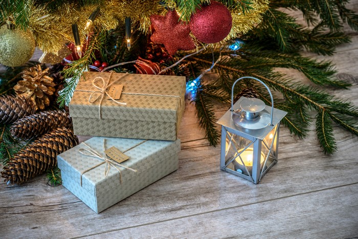Christmas gifts and lantern under a tree