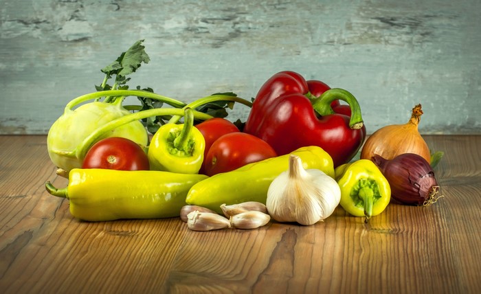 Assortment of fresh vegetables on a wooden table