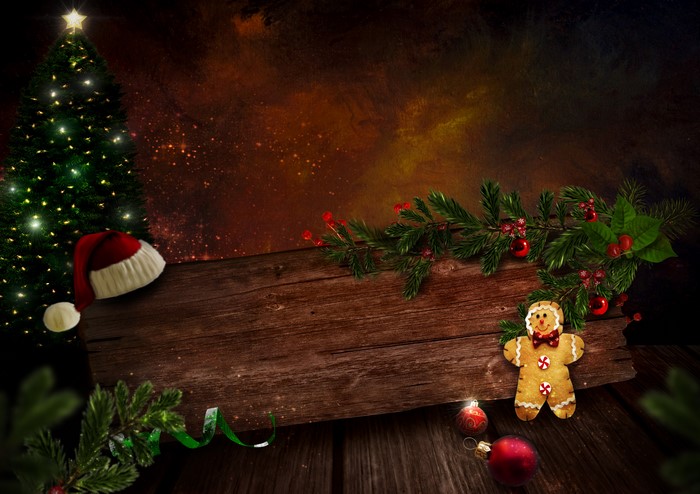 Christmas tree with Santa hat and gingerbread man on wood