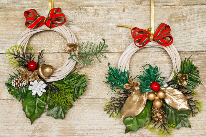 Two Christmas wreaths with bows and ornaments