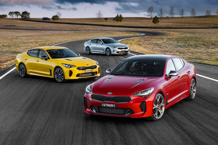Three Kia Stinger GT cars on a race track