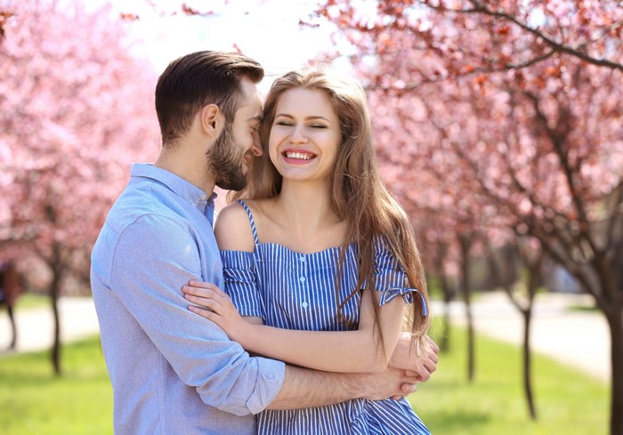 Couple hugging under blooming trees