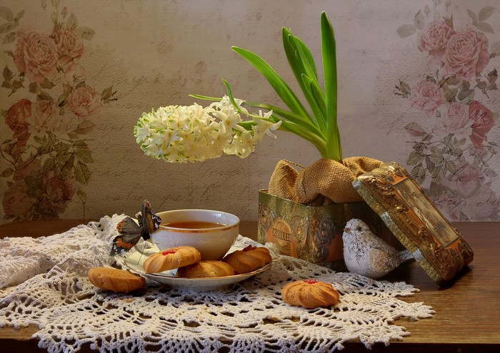 Still-life with tea, cookies, hyacinths, and butterfly