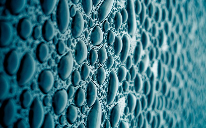 Close-up of water drops on a textured surface