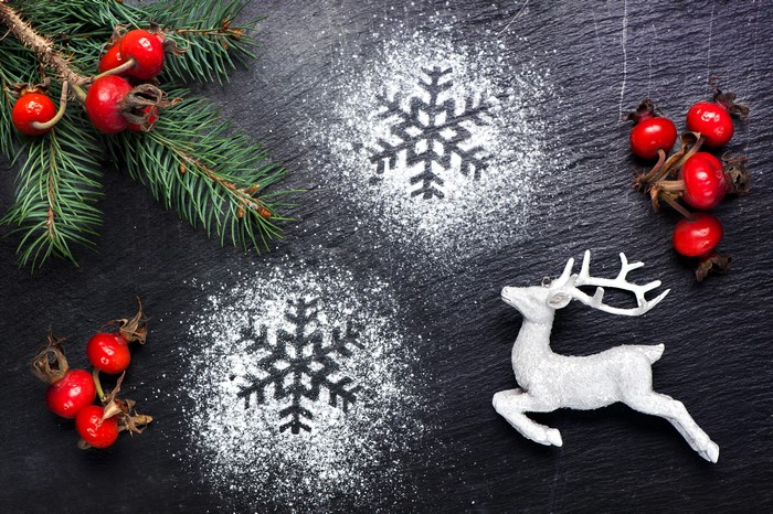 Christmas decoration with fir branches, berries, and deer