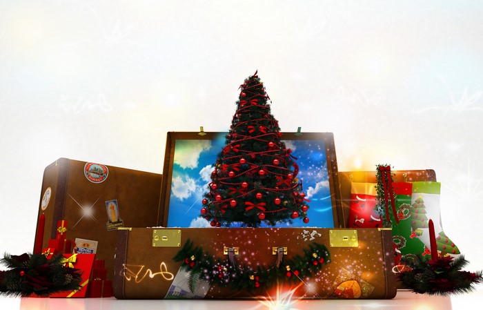 Christmas tree and gifts in suitcases