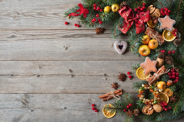 Christmas Decorations with Pine Cones and Oranges on Wood