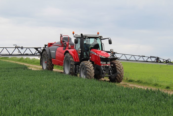 Massey Ferguson 7718 tractor spraying a field