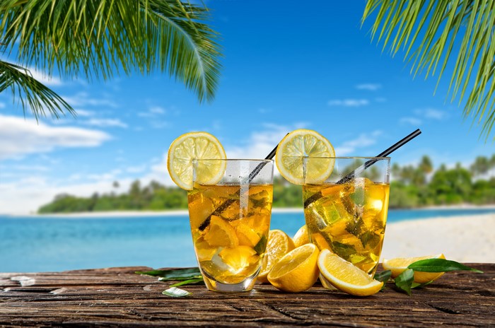 Two lemonades with lemons on a beach