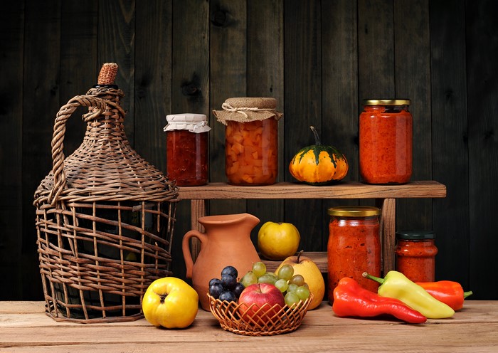 Still-life with jars of preserves, fruit, and peppers