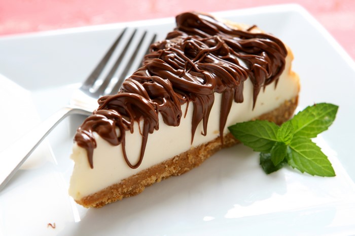 Cheesecake slice with chocolate drizzle and mint