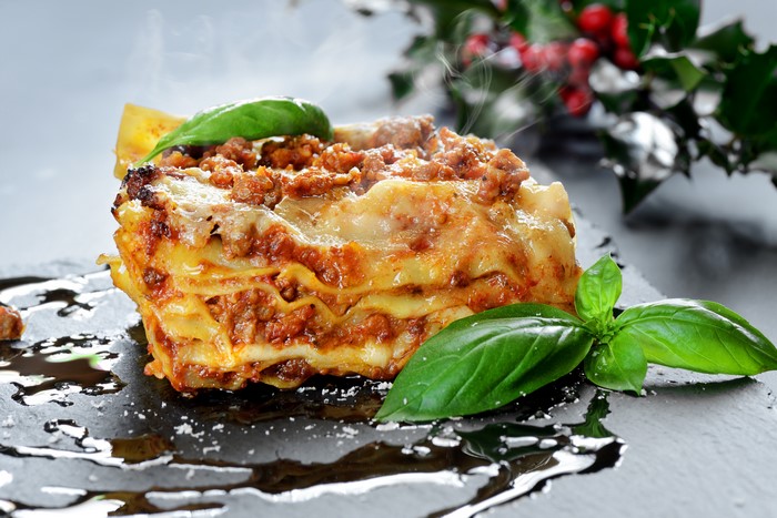 Lasagne with basil on a dark plate