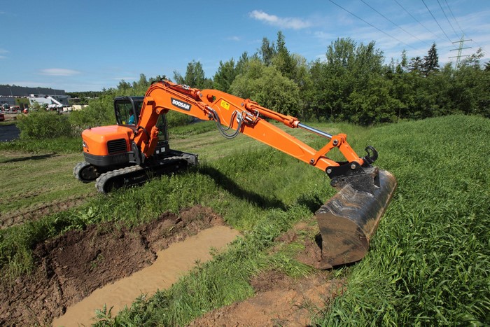 Doosan DX85R-3 excavator digging a trench