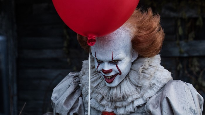 Pennywise the Clown from It holding a red balloon