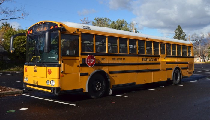 Yellow school bus with "First Student" branding