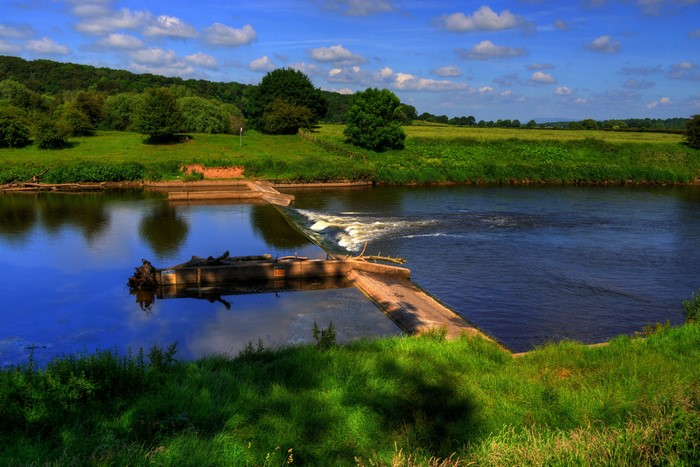 River with Weir and Green Landscape