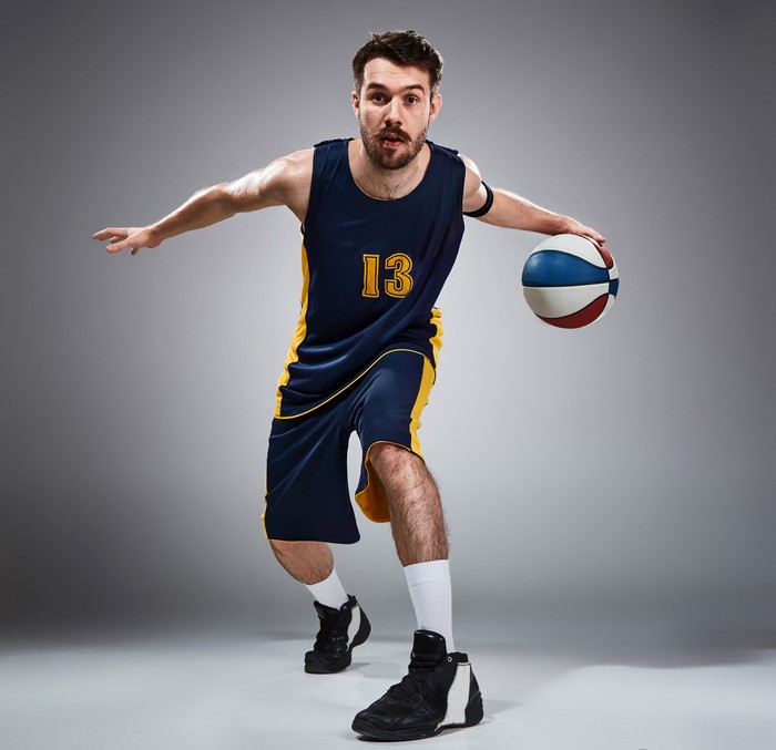 Man in basketball uniform dribbling a ball