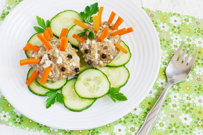 Hedgehog shaped food with cucumbers on a plate