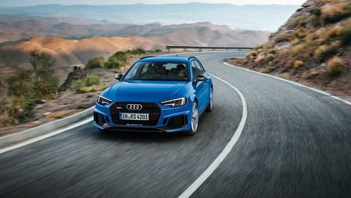 Blue Audi RS4 Avant driving on a mountain road