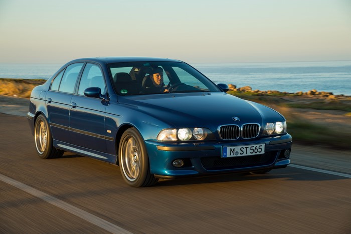 Blue 1998-2003 BMW M5 driving on a coastal road