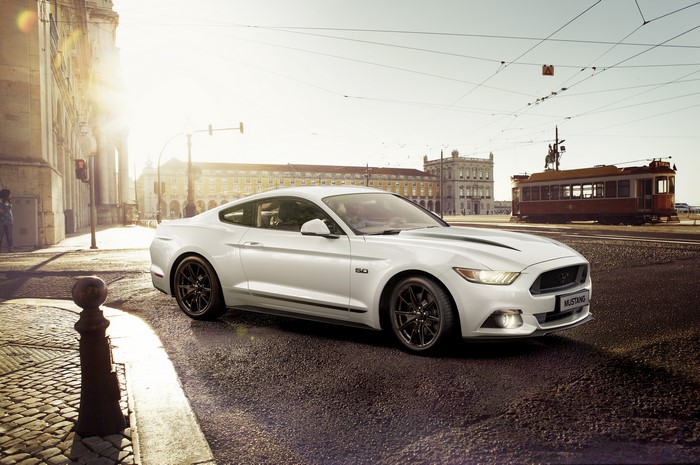 White Ford Mustang 5.0 on a city street