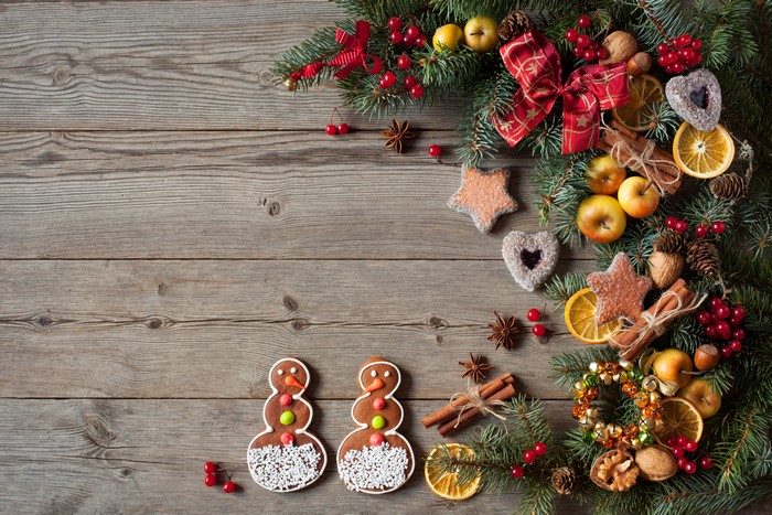 Christmas decorations with cookies and apples on wood