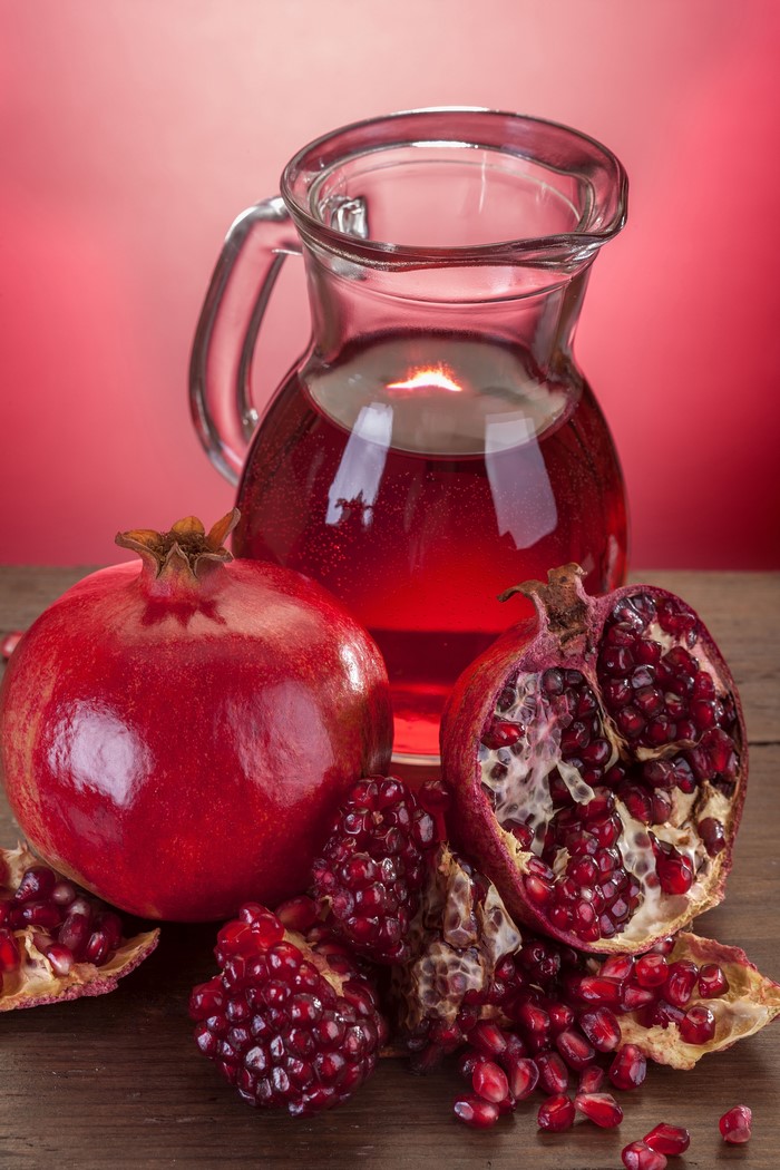 Pomegranate juice in a jug with pomegranates