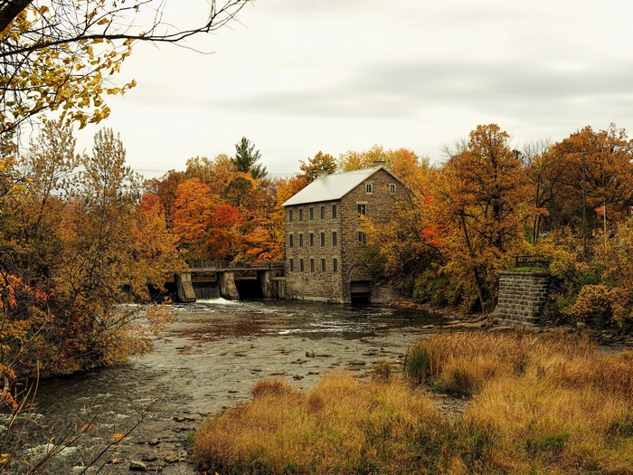 Stone Mill by a River in Autumn