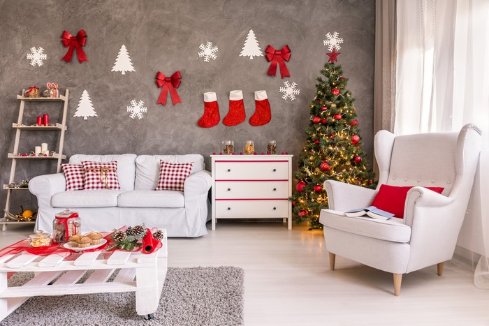 Christmas decorated living room with sofa and armchair