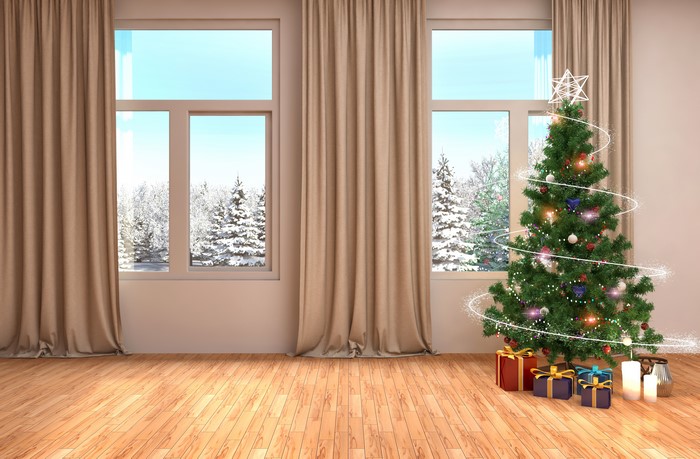 Christmas Tree with Gifts and Candles by the Window