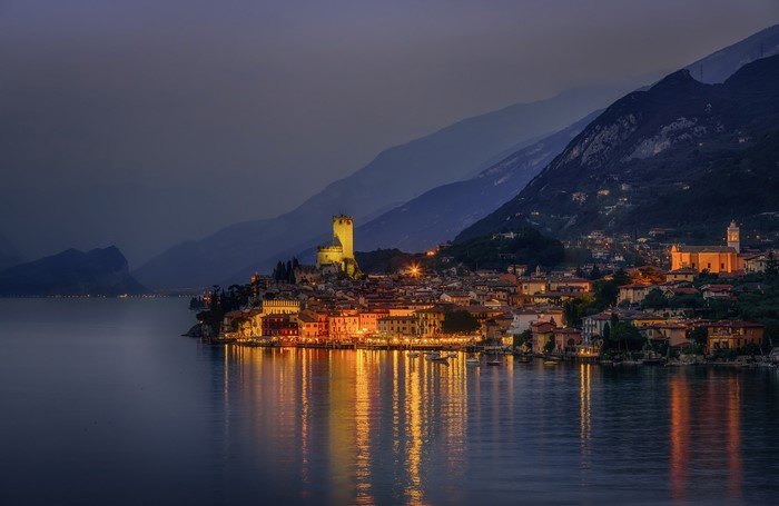 Malcesine, Italy at night with lake and mountains