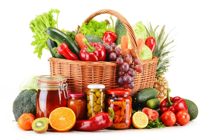 Vegetables and Fruits in a Wicker Basket with Jars