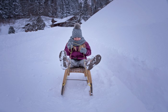 Girl on a sled in the snow