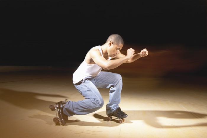 Man on roller skates in a crouched pose