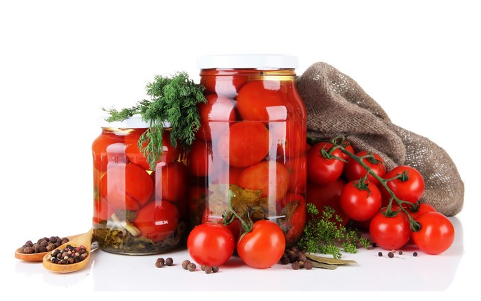 Jars of Pickled Tomatoes with Spices and Dill