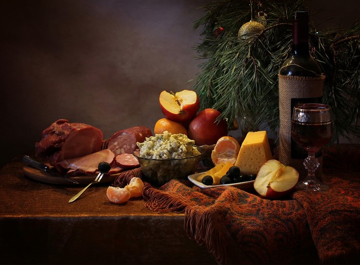 Christmas still-life with ham, cheese, apples, and wine