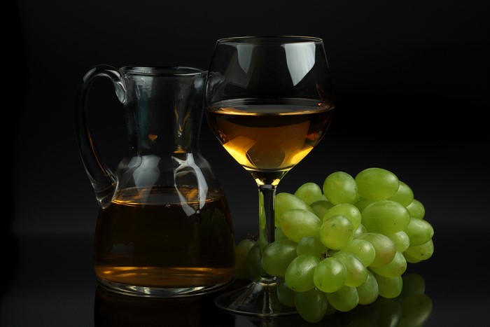 White Wine in a Glass and Carafe with Grapes