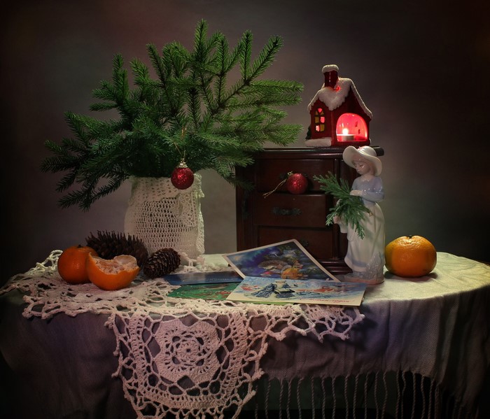 Christmas still-life with fir branches, oranges, and postcards