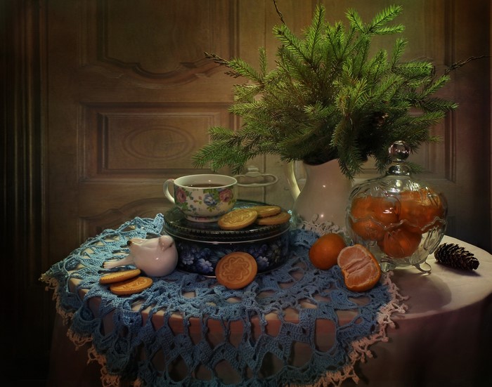Still-life with tangerines, cookies, and a cup of tea